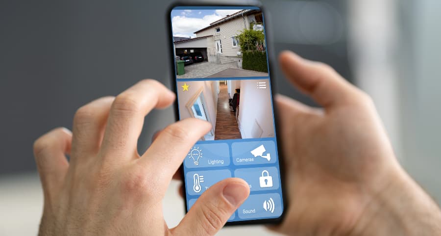 Homeowner checking video camera feeds on a smartphone