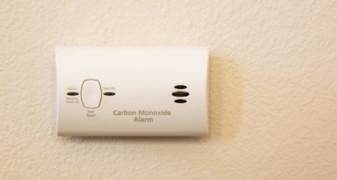 Carbon monoxide detector attached to wall of home